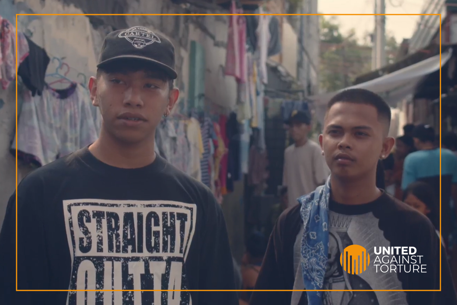 Two young Philippino men standing in a street.